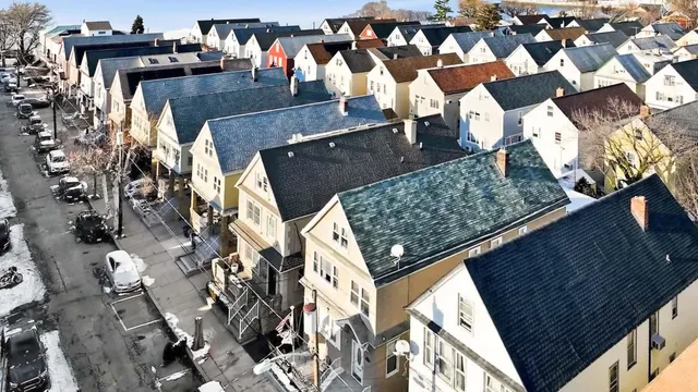 an aerial view of residential houses with outdoor space