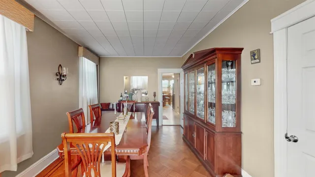 a dining room with furniture window and wooden floor