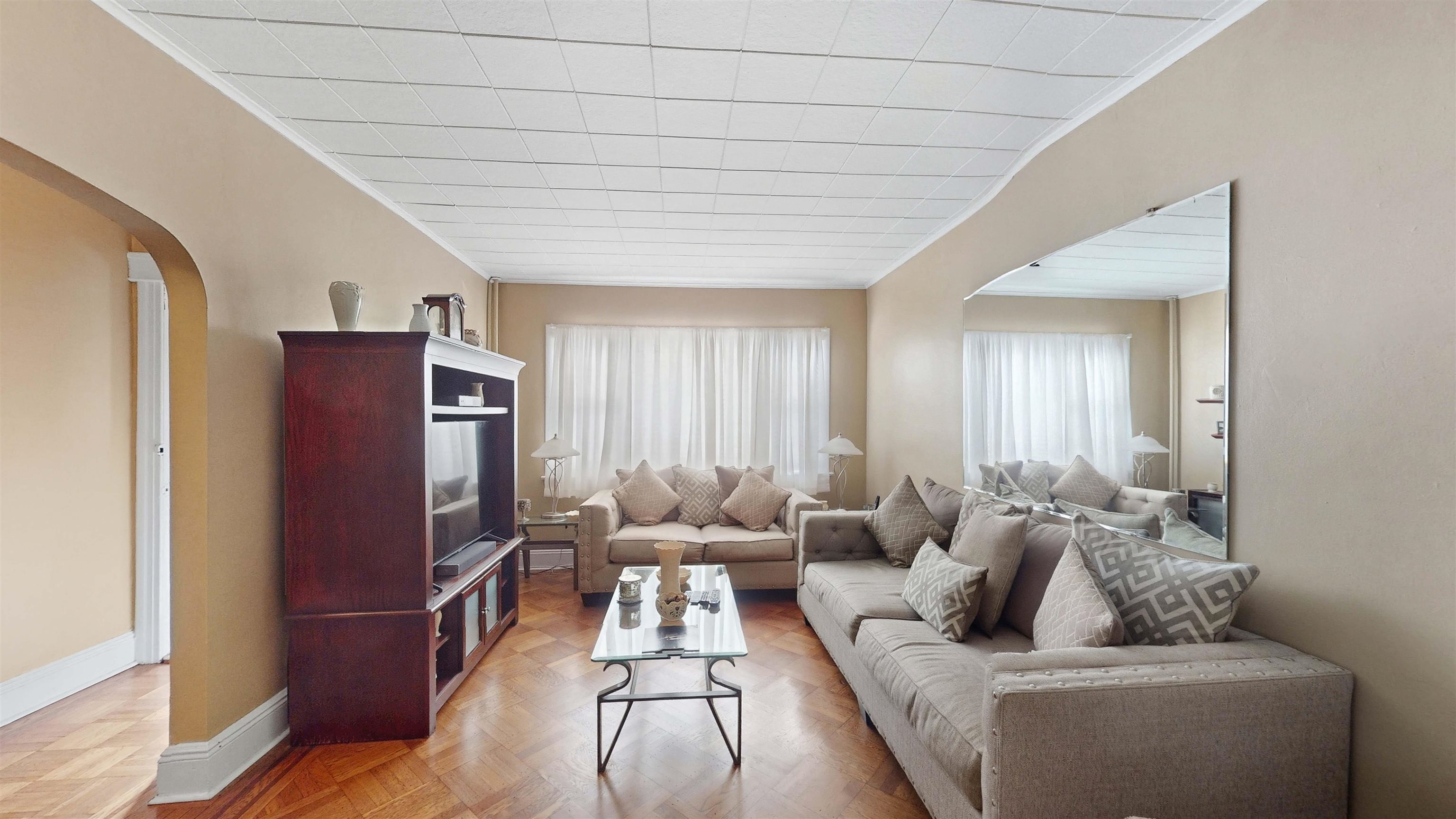 159 West 32nd Street Bayonne, NJ 07002 - Photo 8 of 47 a living room with furniture and a flat screen tv