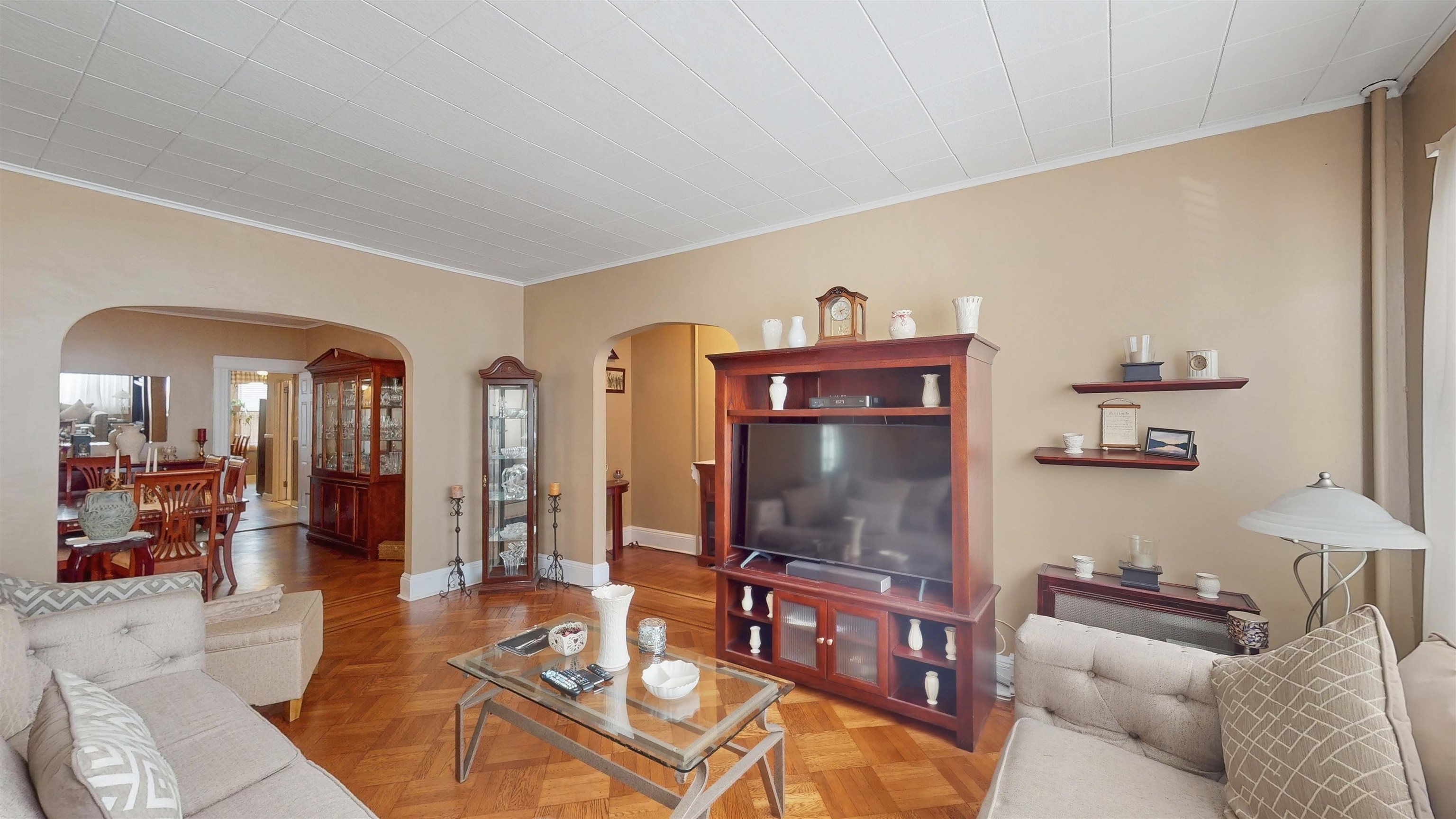 159 West 32nd Street Bayonne, NJ 07002 - Photo 9 of 47 a living room with furniture a flat screen tv and a dining table