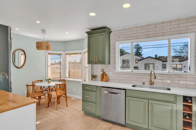 a kitchen with stainless steel appliances granite countertop a sink and wooden cabinets
