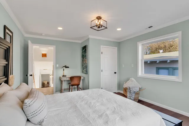 a bedroom with a bed and a chandelier