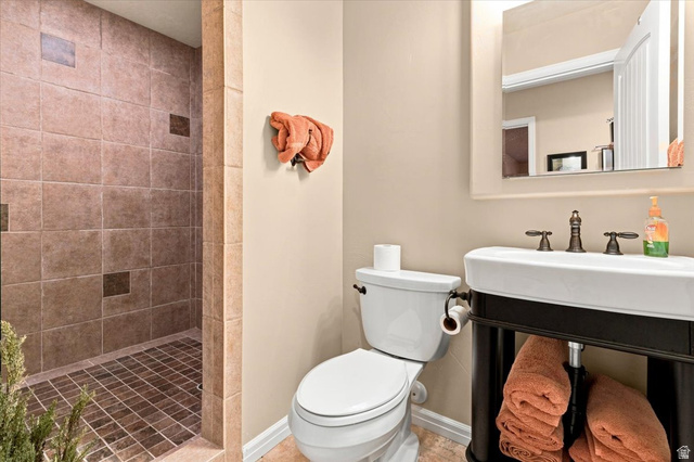 11290 South Southfield Road Mayfield, UT 84643 - Photo 81 of 103 Walk-in shower with tiled walls and floor, pedestal sink with dark bronze fixtures, wall-mounted mirror, and toilet