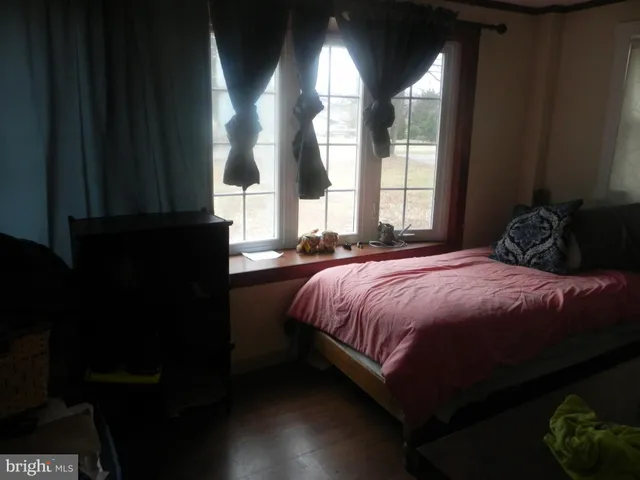 a bedroom with bed and a window