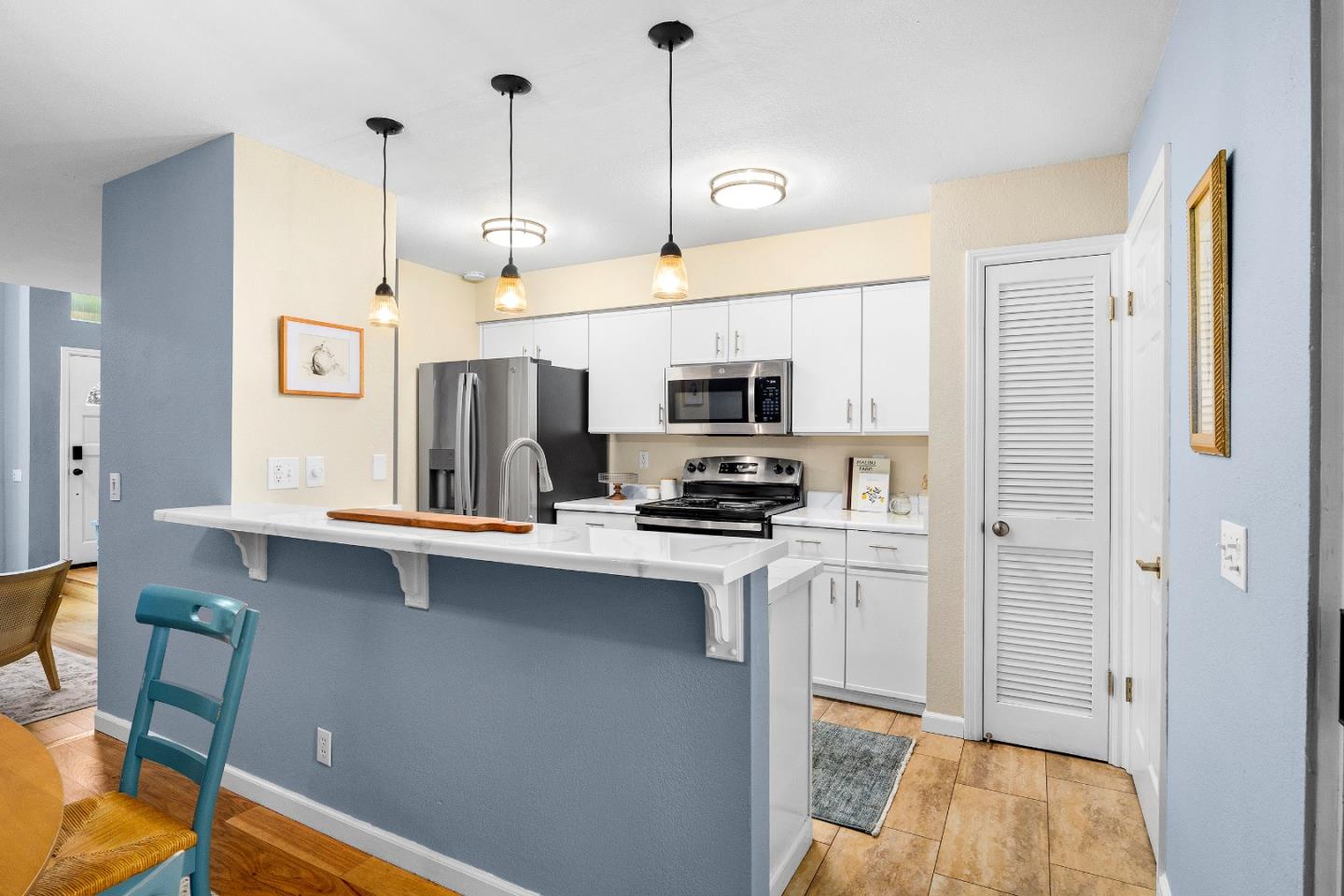1644 Ocean Street Santa Cruz, CA 95060 - Photo 18 of 60 a kitchen with stainless steel appliances a stove refrigerator sink and microwave