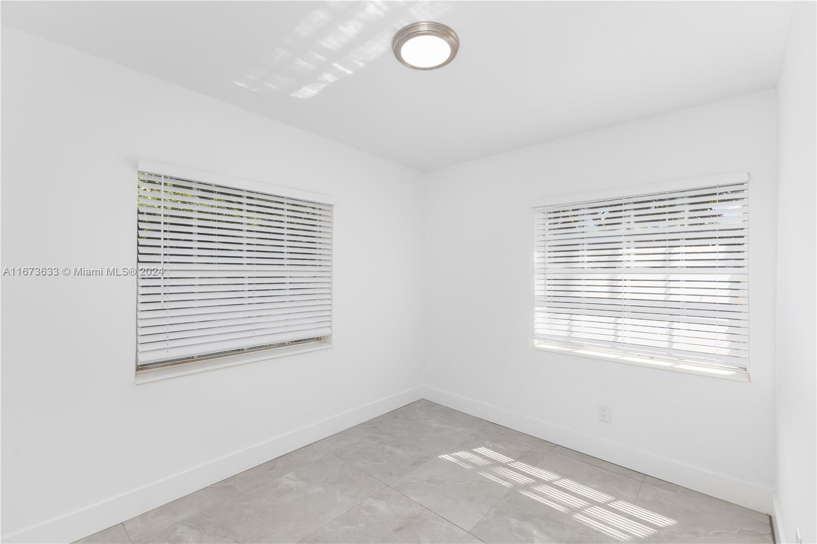 2320 Northwest 55th Street Miami, FL 33142 - Photo 11 of 34 a view of an empty room with a window
