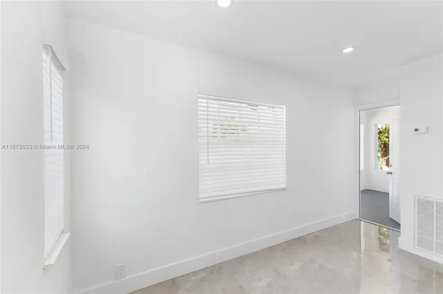 a view of empty room with windows and entryway