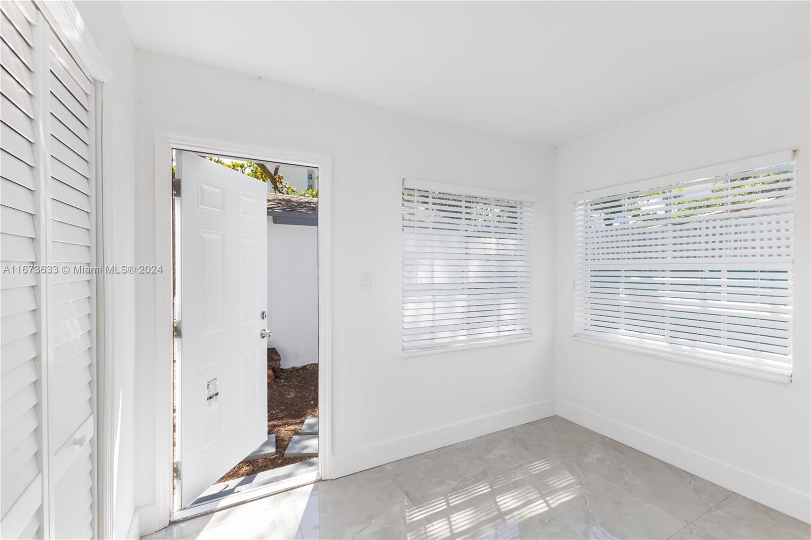 2320 Northwest 55th Street Miami, FL 33142 - Photo 24 of 34 a view of an empty room with a window