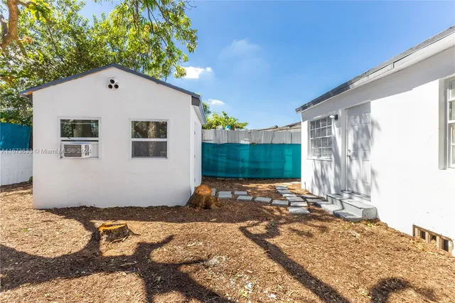 a backyard of a house with seating space