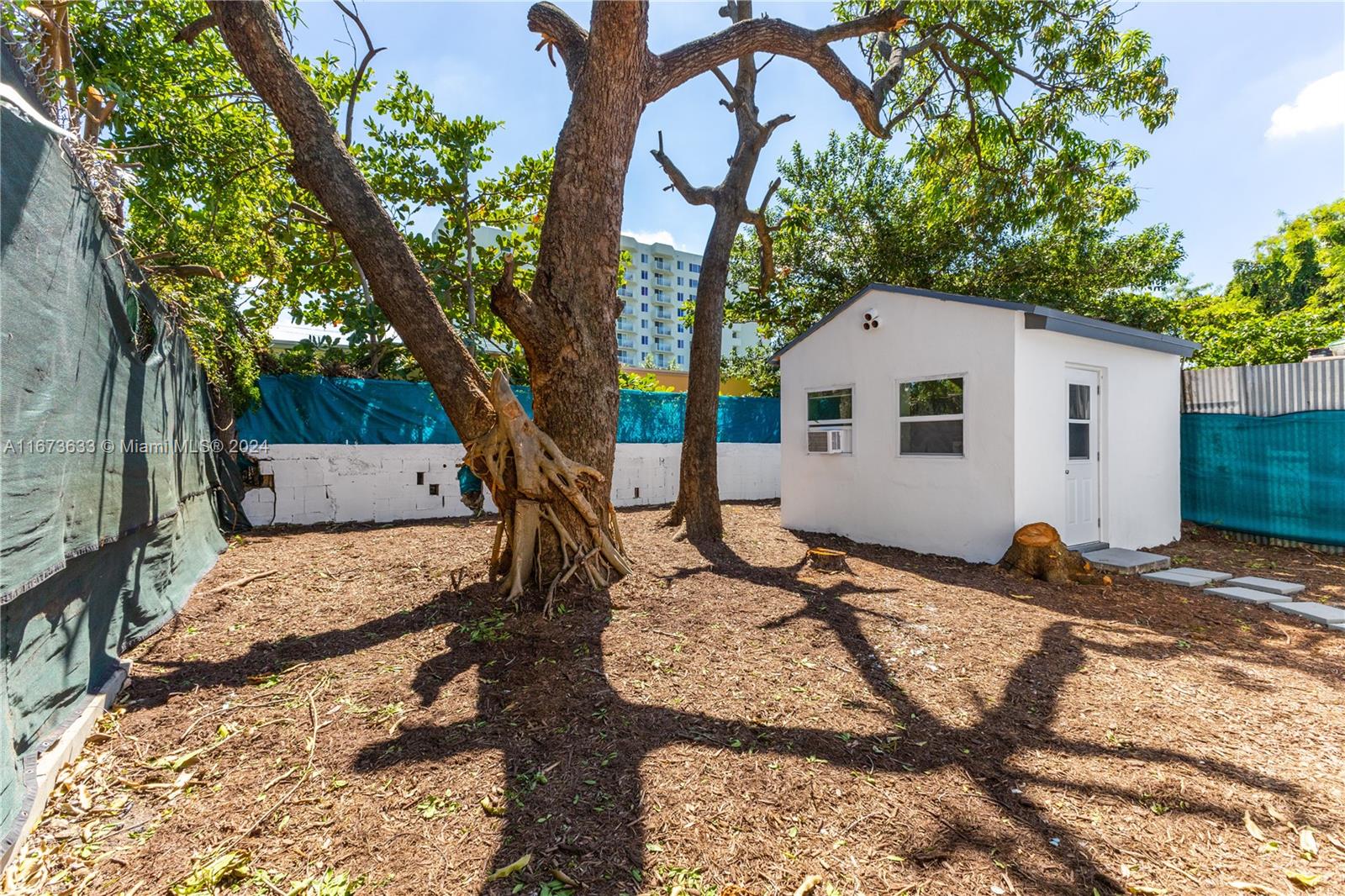 2320 Northwest 55th Street Miami, FL 33142 - Photo 27 of 34 a backyard of a house with seating space