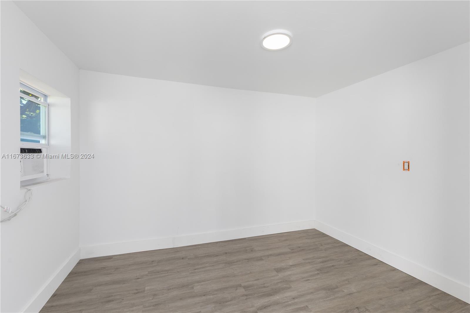 2320 Northwest 55th Street Miami, FL 33142 - Photo 29 of 34 a view of an empty room with wooden floor