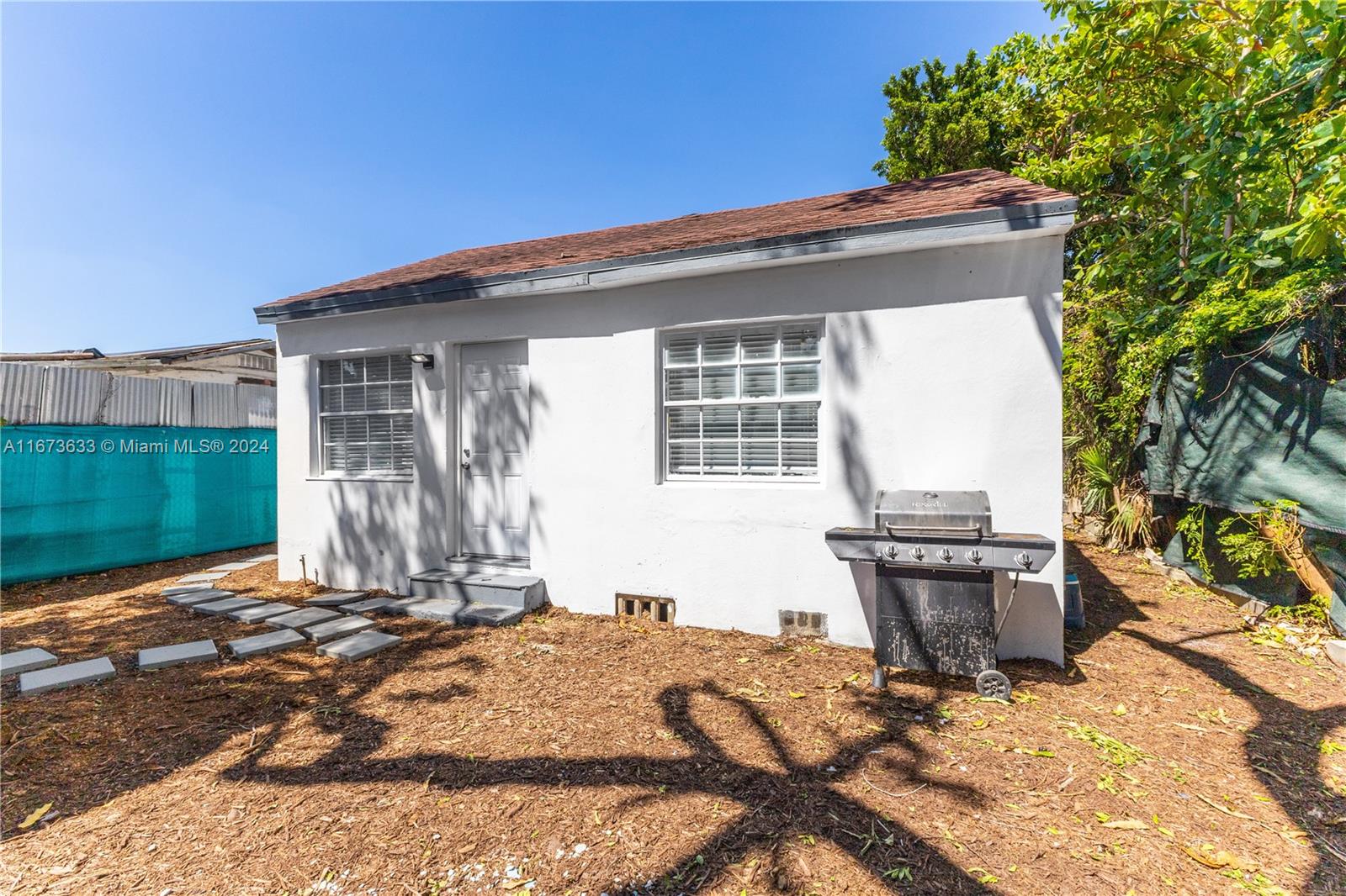2320 Northwest 55th Street Miami, FL 33142 - Photo 30 of 34 a front view of a house with a yard