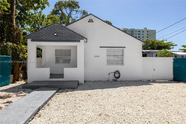 a front view of a house with sitting area
