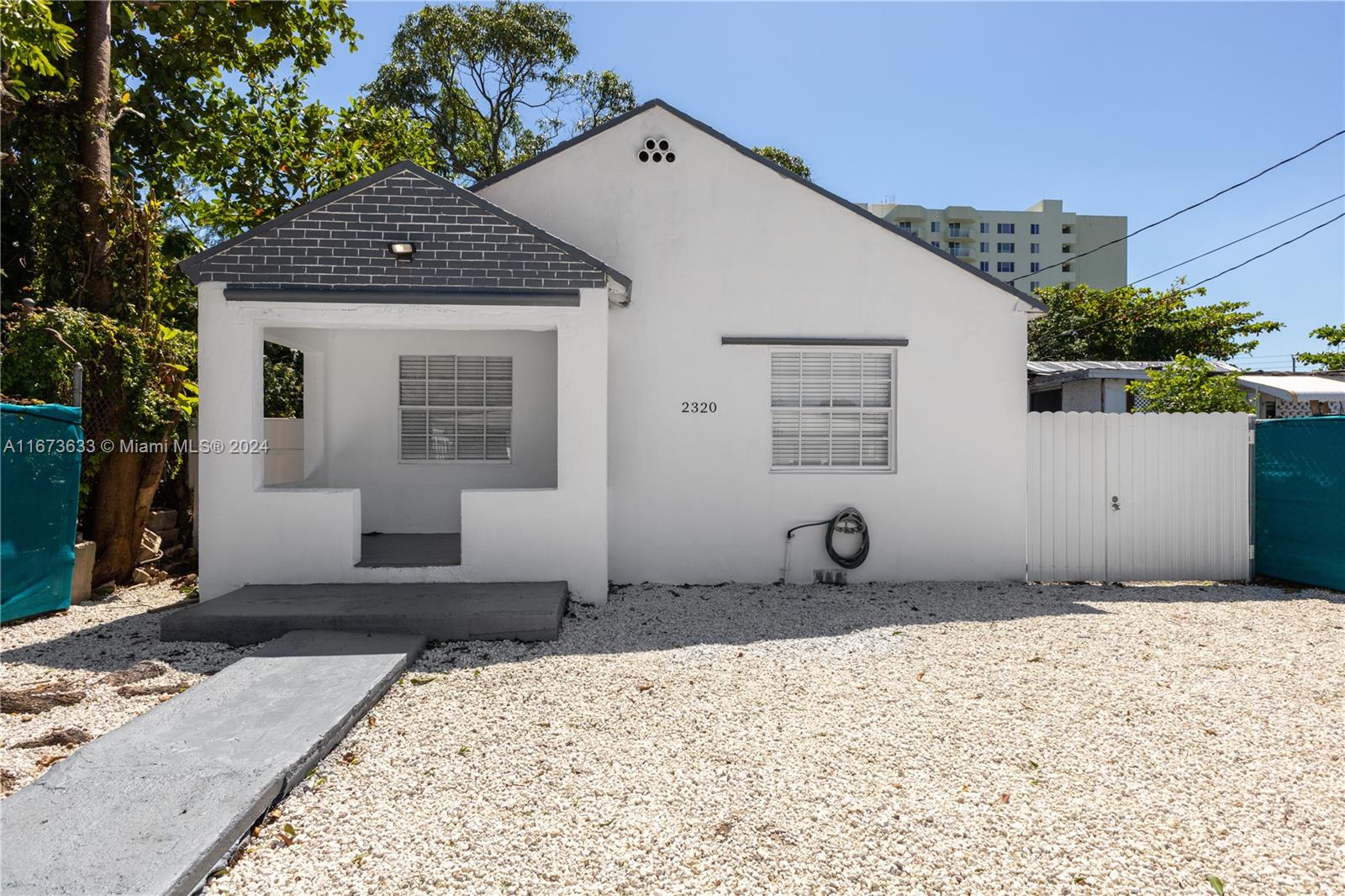 2320 Northwest 55th Street Miami, FL 33142 - Photo 4 of 34 a front view of a house with sitting area