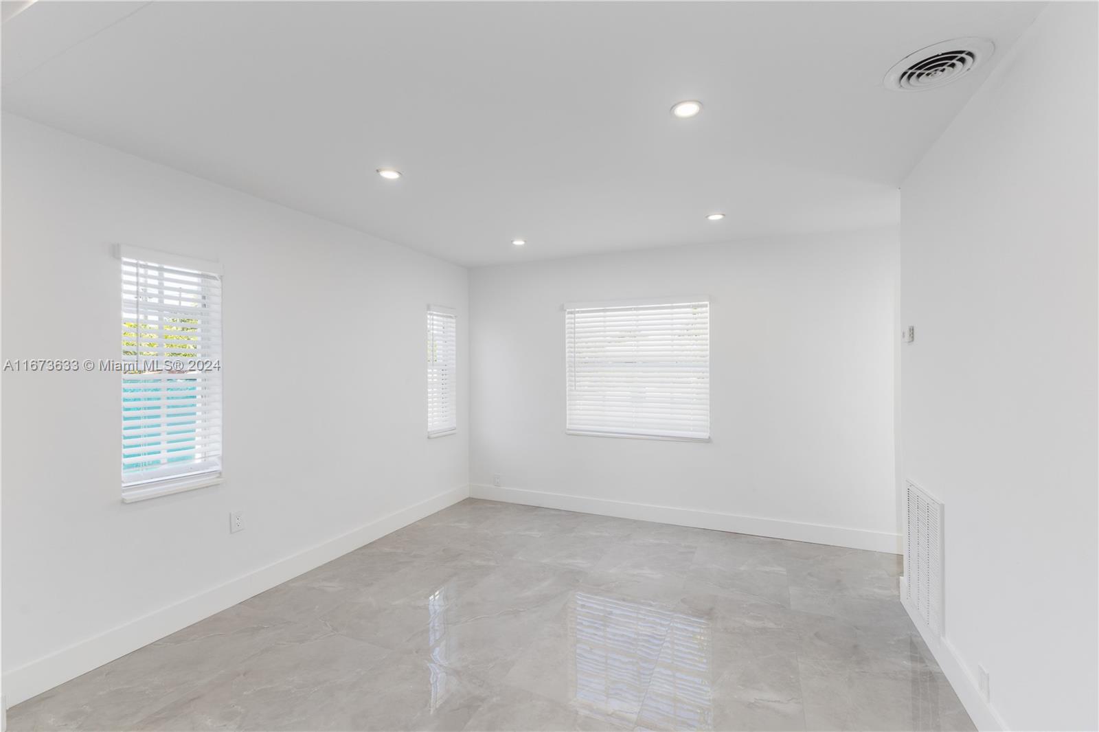 2320 Northwest 55th Street Miami, FL 33142 - Photo 10 of 34 an empty room with windows