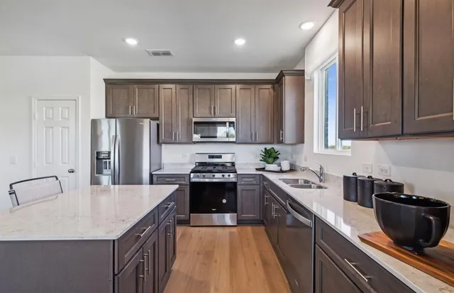 a kitchen with a sink stove and refrigerator
