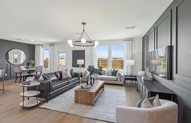 a living room with fireplace furniture and a chandelier