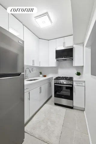 a kitchen with stainless steel appliances and white cabinets