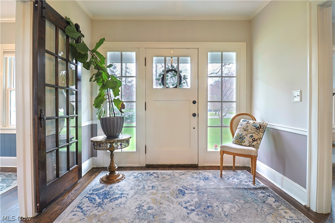 4376 Dover Center Road North Olmsted, OH 44070 - Photo 2 of 34 Foyer entrance with ornamental molding, dark wood-type flooring, and a barn door