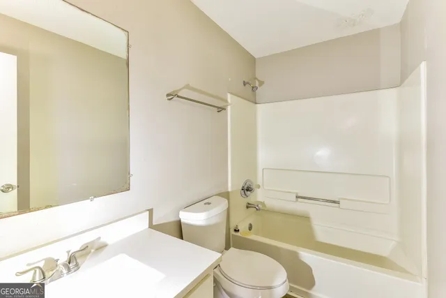 a bathroom with a toilet a sink and bathtub
