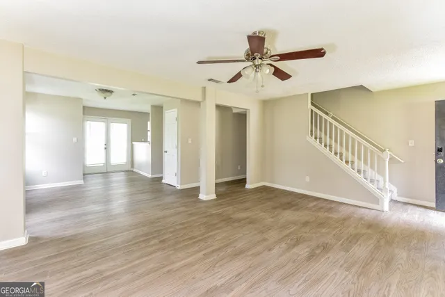 a view of an empty room and wooden floor