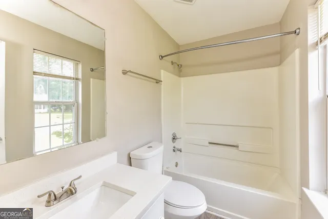 a bathroom with a toilet a sink and a bathtub