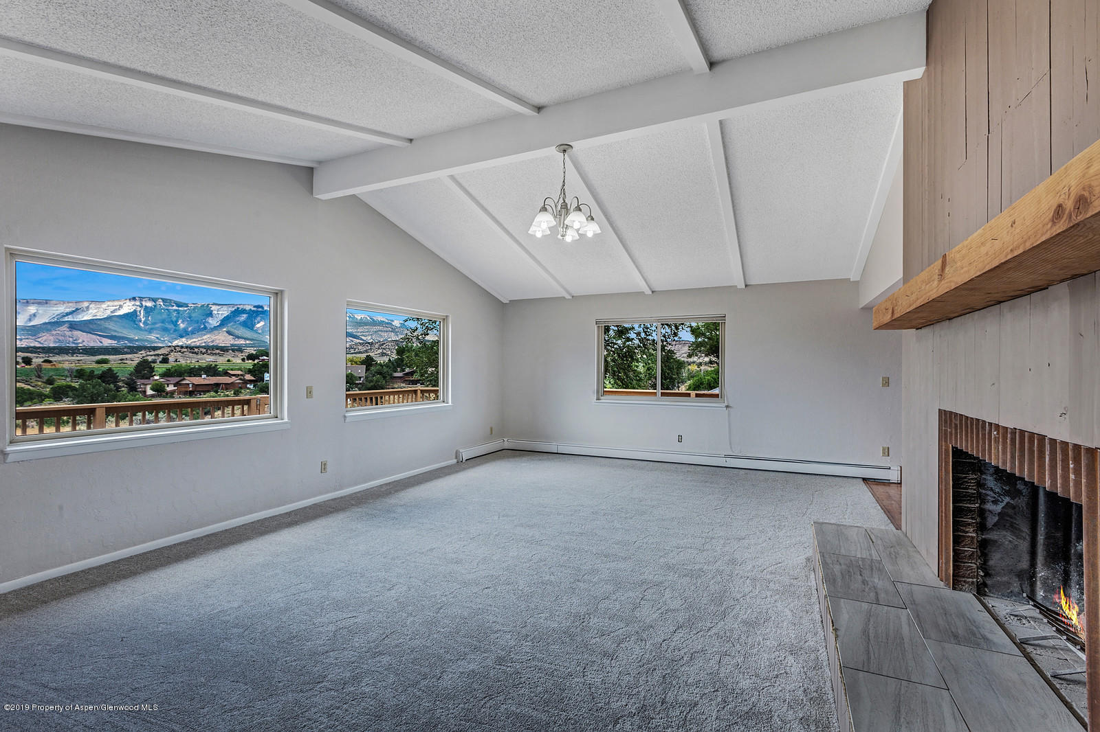 315 Will Avenue Rifle, CO 81650 - Photo 3 of 26 an empty room with windows