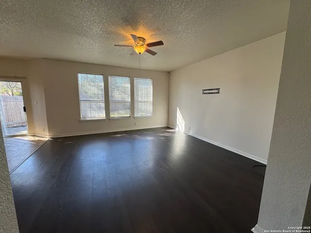a large kitchen with granite countertop a large counter top stainless steel appliances and cabinets