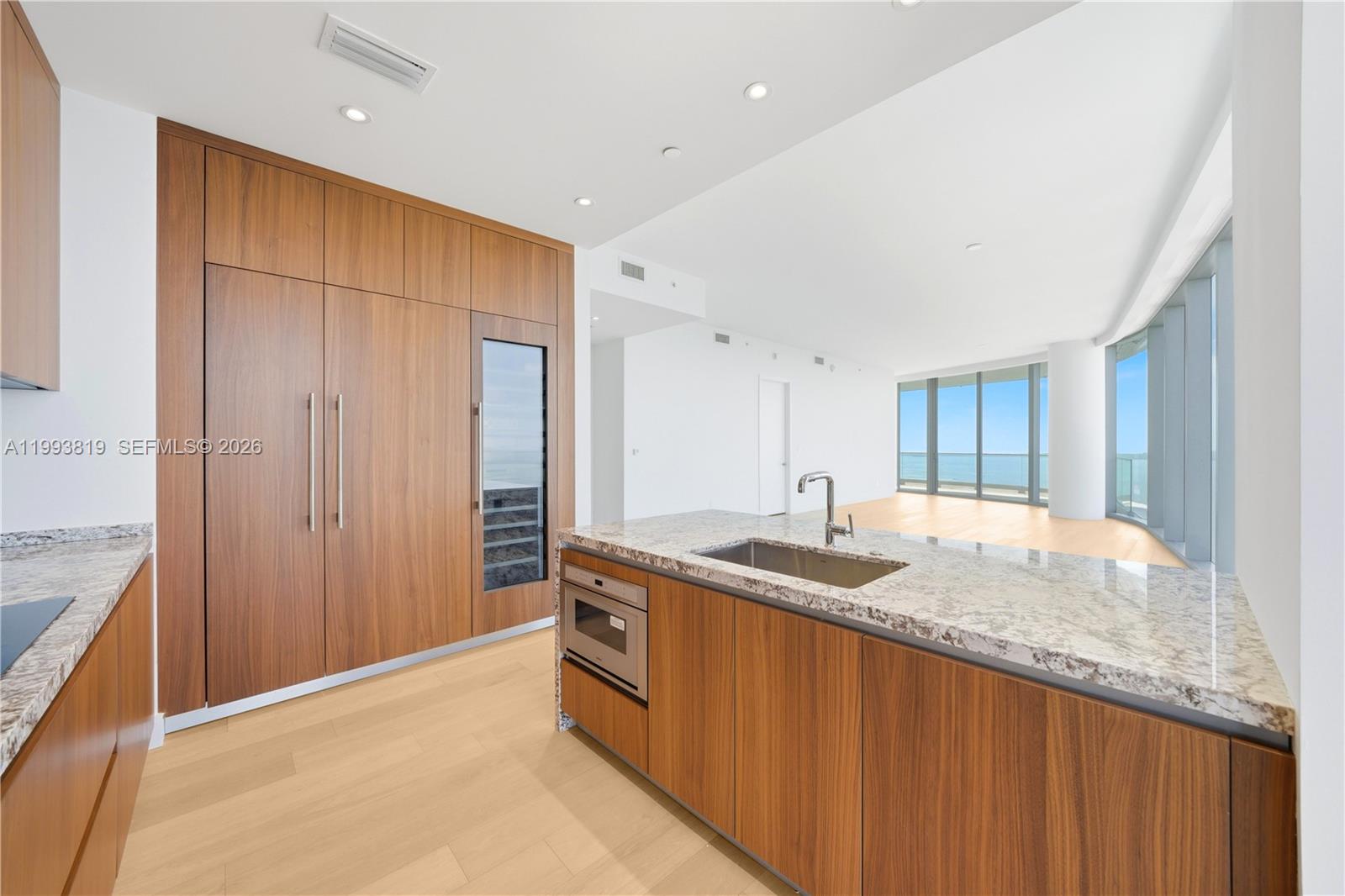 175 Southeast 25th Road, Unit 3102 Miami, FL 33129 - Photo 10 of 65 a kitchen with kitchen island granite countertop a sink and a granite counter top