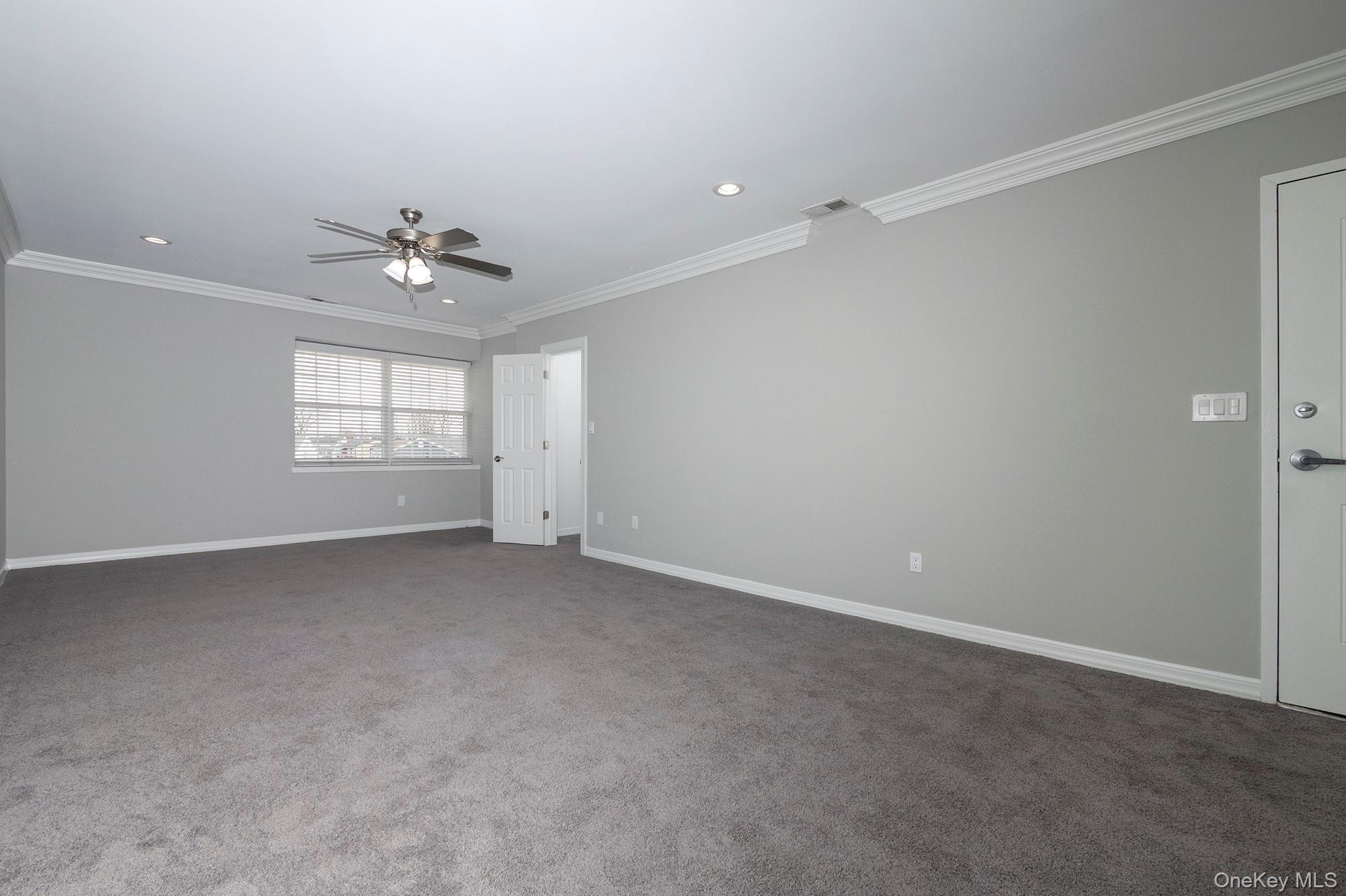 425 Newbridge Road, Unit 28 East Meadow, NY 11554 - Photo 4 of 8 a view of an empty room with a window