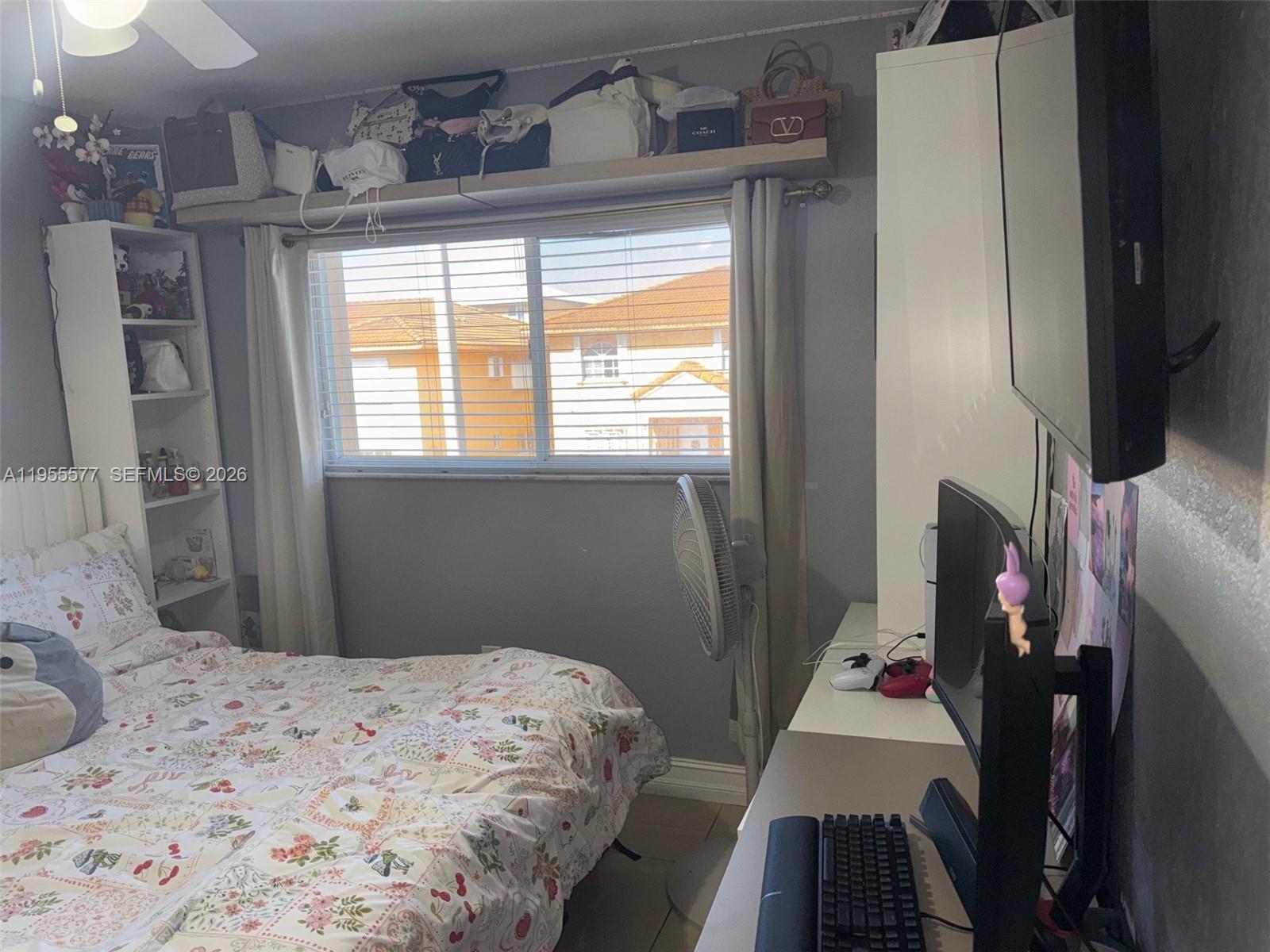 3375 West 76th Street, Unit 223 Hialeah, FL 33018 - Photo 11 of 26 a bedroom with a bed and wooden floor