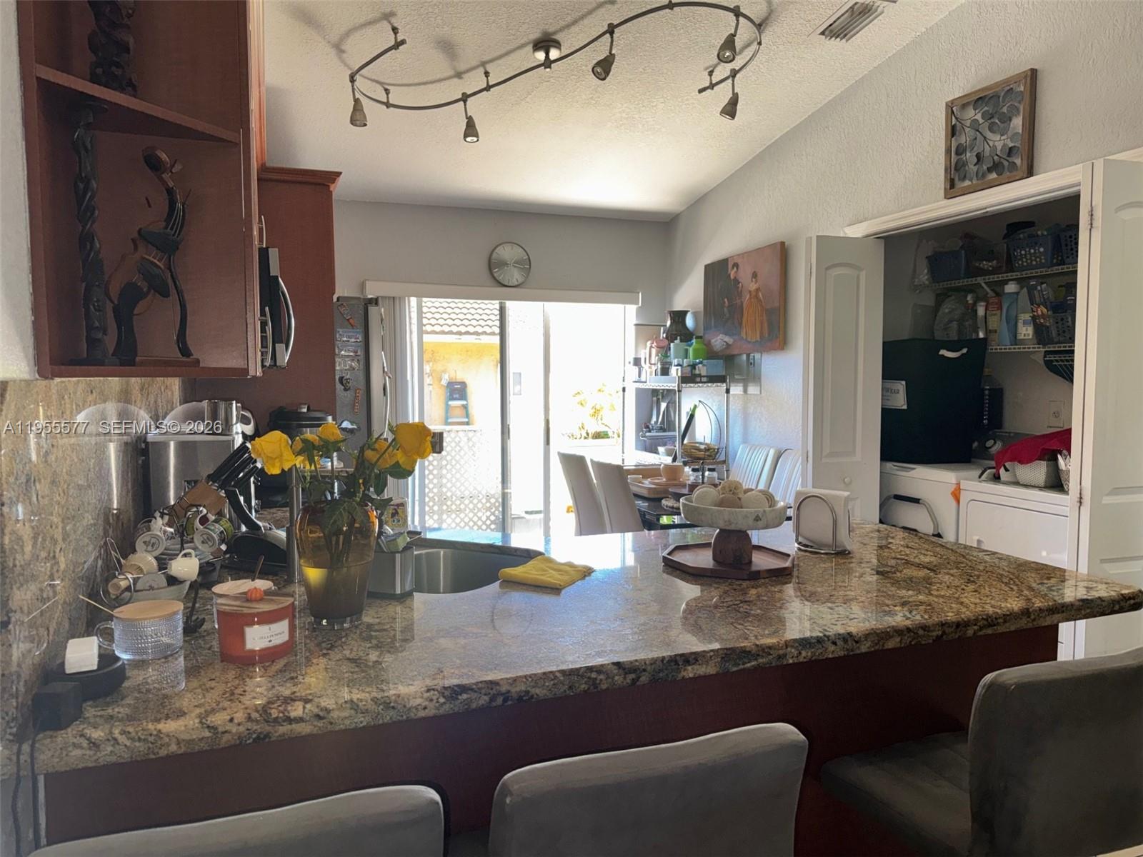 3375 West 76th Street, Unit 223 Hialeah, FL 33018 - Photo 15 of 26 a kitchen with counter top space cabinets and furniture