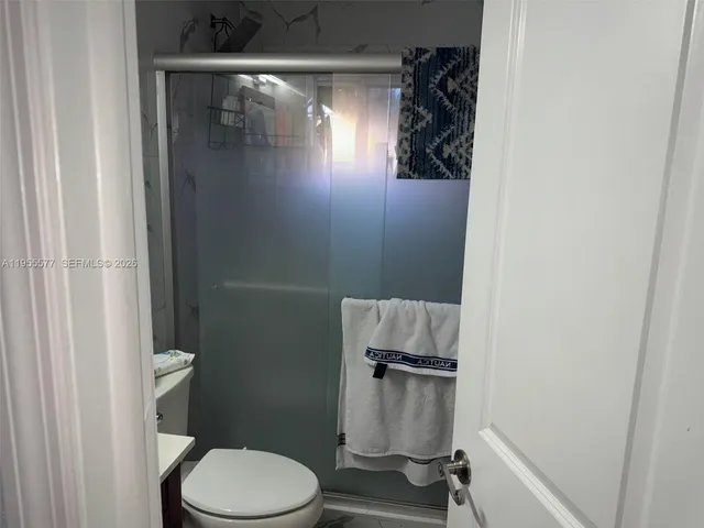 a bathroom with a toilet and a shower
