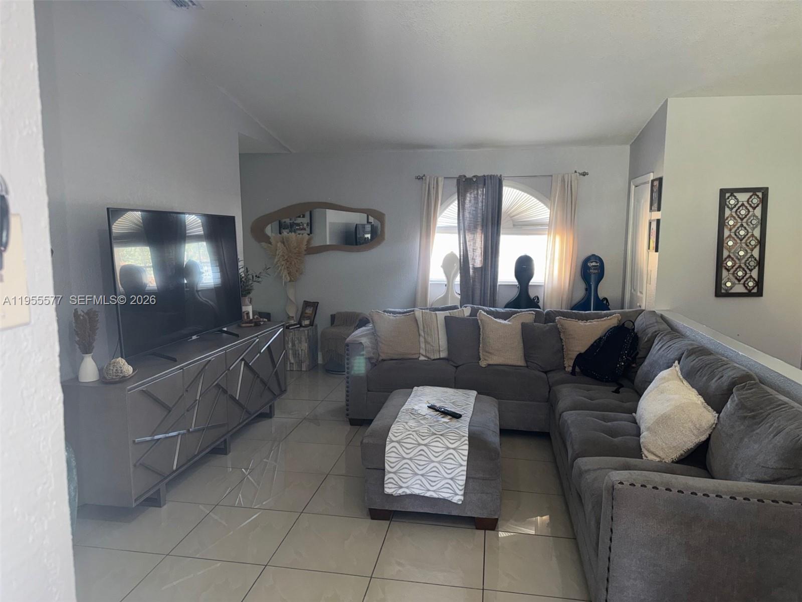 3375 West 76th Street, Unit 223 Hialeah, FL 33018 - Photo 4 of 26 a living room with furniture and a flat screen tv