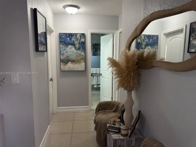 a living room with furniture and a painting on the wall