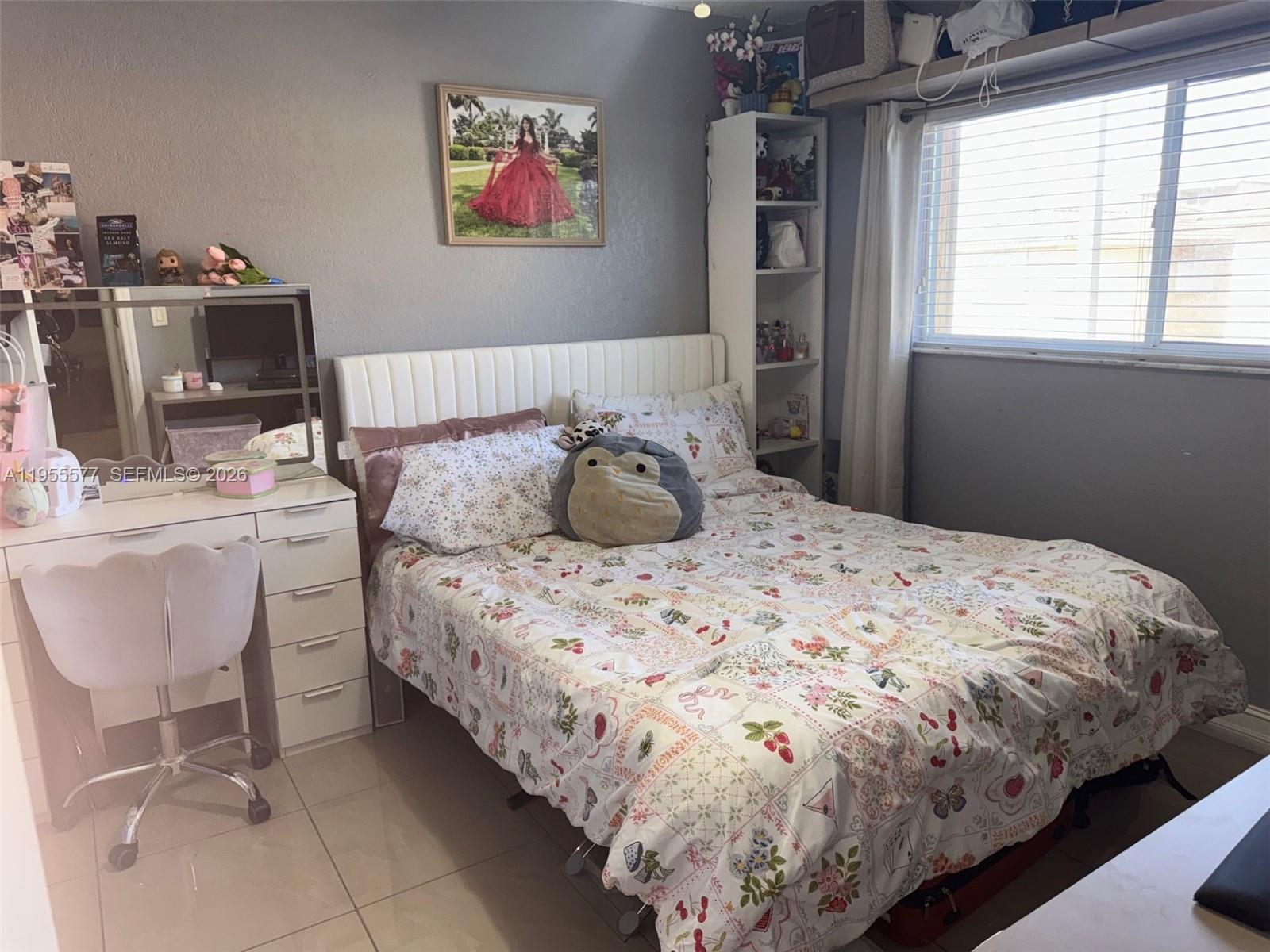 3375 West 76th Street, Unit 223 Hialeah, FL 33018 - Photo 10 of 26 a bedroom with a bed and a chair