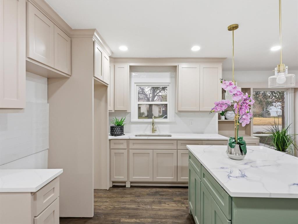 6624 Reeves Street Richland Hills, TX 76118 - Photo 12 of 27 a kitchen with a sink dishwasher and a refrigerator with wooden floor