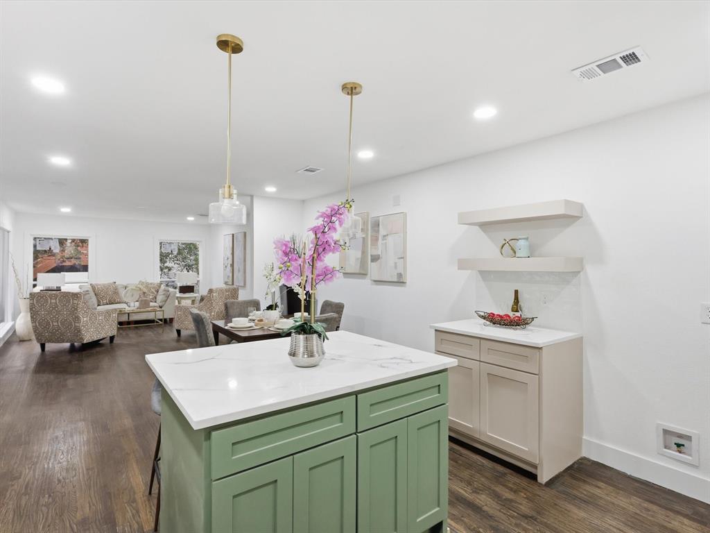 6624 Reeves Street Richland Hills, TX 76118 - Photo 14 of 27 a room with kitchen island a sink and wooden floor