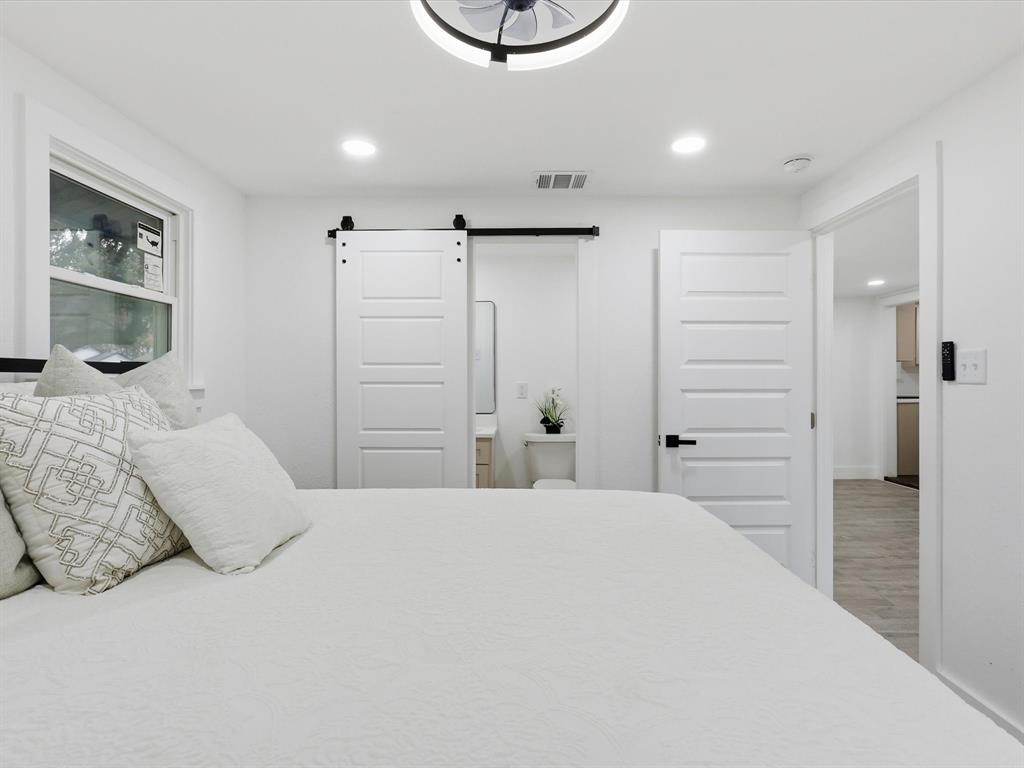 6624 Reeves Street Richland Hills, TX 76118 - Photo 18 of 27 a bedroom with a bed and a cabinets