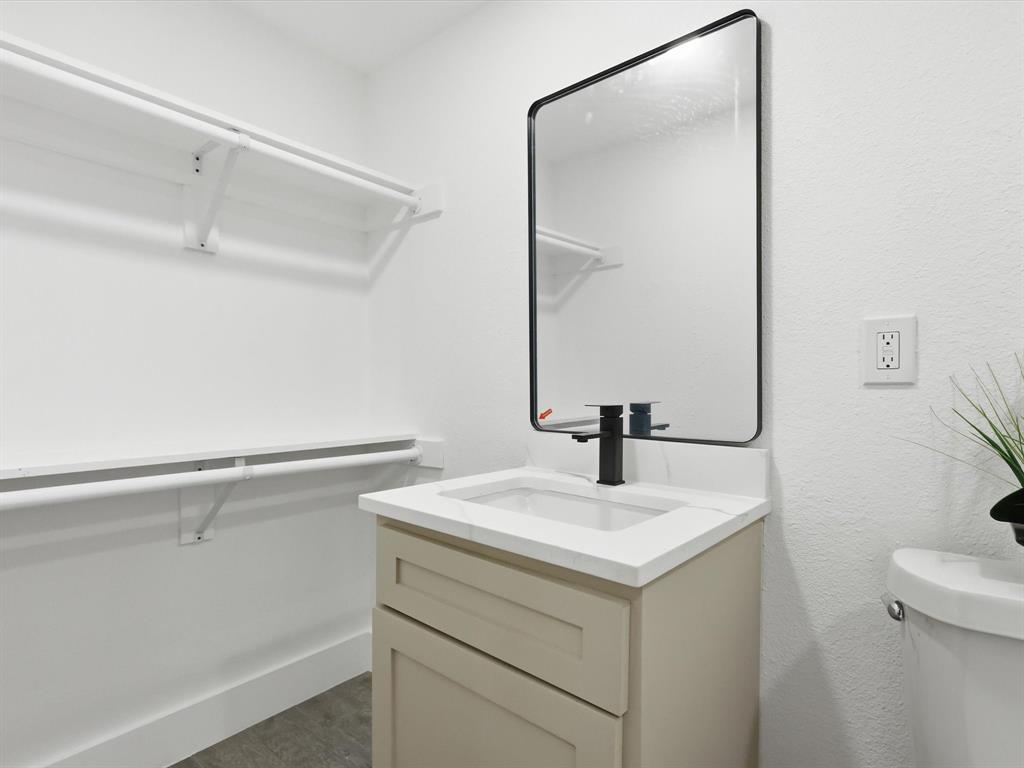 6624 Reeves Street Richland Hills, TX 76118 - Photo 19 of 27 a bathroom with a sink vanity and toilet