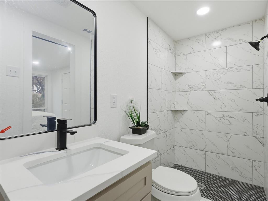 6624 Reeves Street Richland Hills, TX 76118 - Photo 20 of 27 a bathroom with a sink a toilet and shower