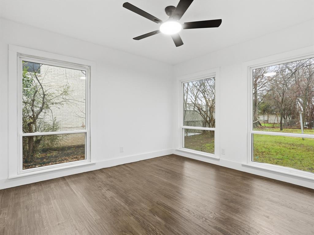 6624 Reeves Street Richland Hills, TX 76118 - Photo 21 of 27 a view of an empty room with wooden floor and a window