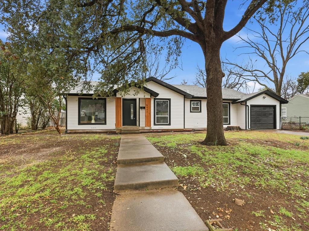 6624 Reeves Street Richland Hills, TX 76118 - Photo 5 of 27 a front view of a house with a garden