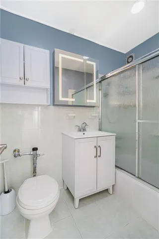a bathroom with a sink toilet and mirror