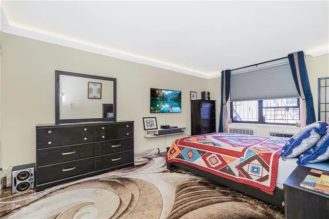 a bedroom with a bed and a flat screen television