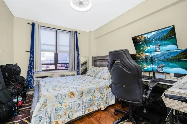 a bedroom with furniture and a flat screen tv