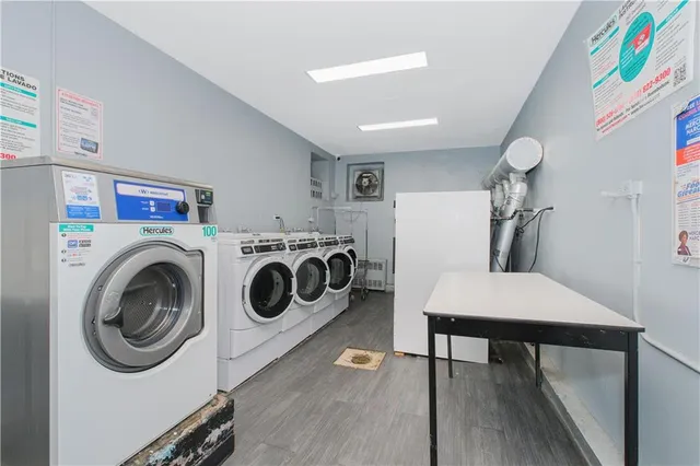 a utility room with dryer washer and a view of living room