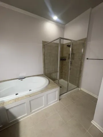 a bathroom with a tub and shower