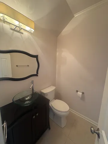 a bathroom with a sink a toilet and mirror