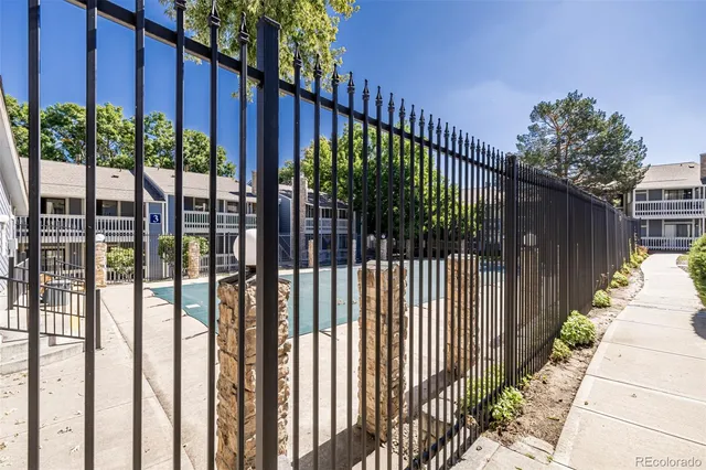 a view of a gate with wooden fence
